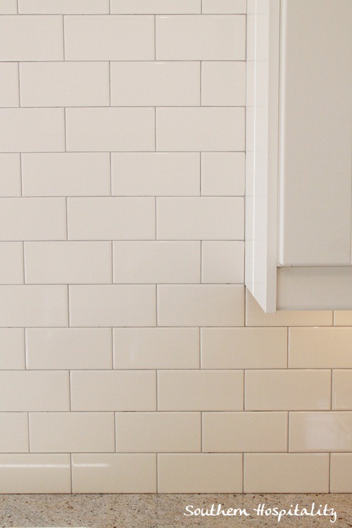 white subway tile backsplash with gray grout