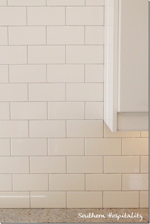 white subway tile backsplash with gray grout