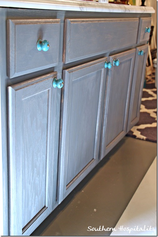 laundry cabinet with turquoise knobs