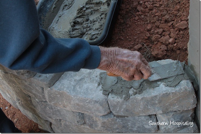 adding mortar to top stones