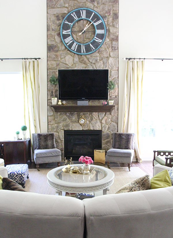 family-room-stone-fireplace-clock-mantel