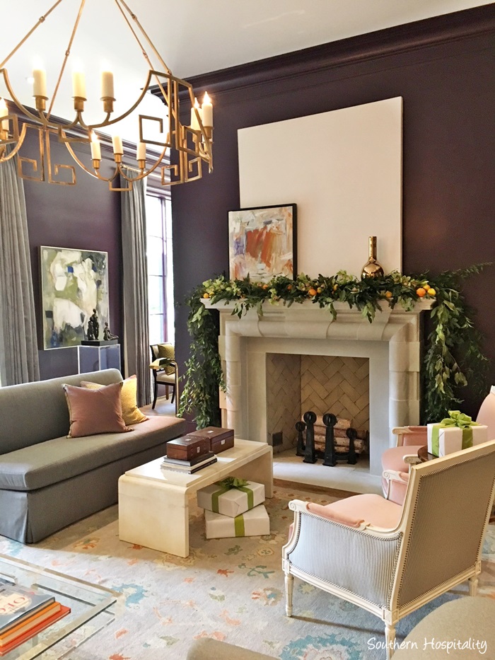 Gorgeous garland on stone fireplace in room painted eggplant in Atlanta holiday showhouse 2017