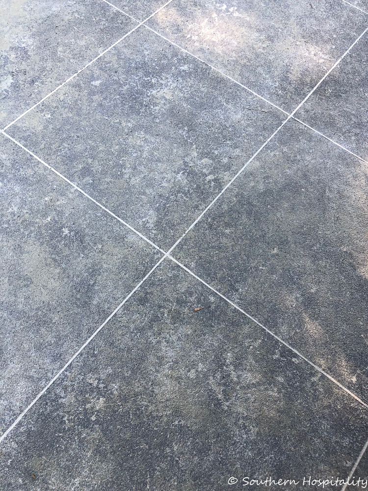 Create a tile look on concrete patio using tape and stone finish paint.