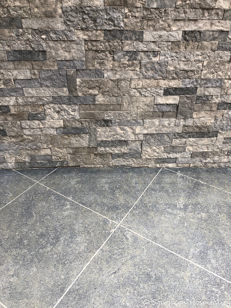 Create a tile look on concrete patio using tape and stone finish paint.