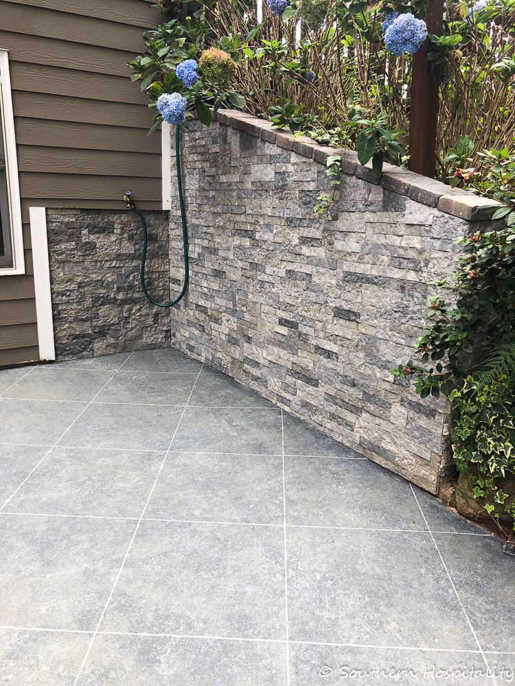 Create a tile look on concrete patio using tape and stone finish paint.