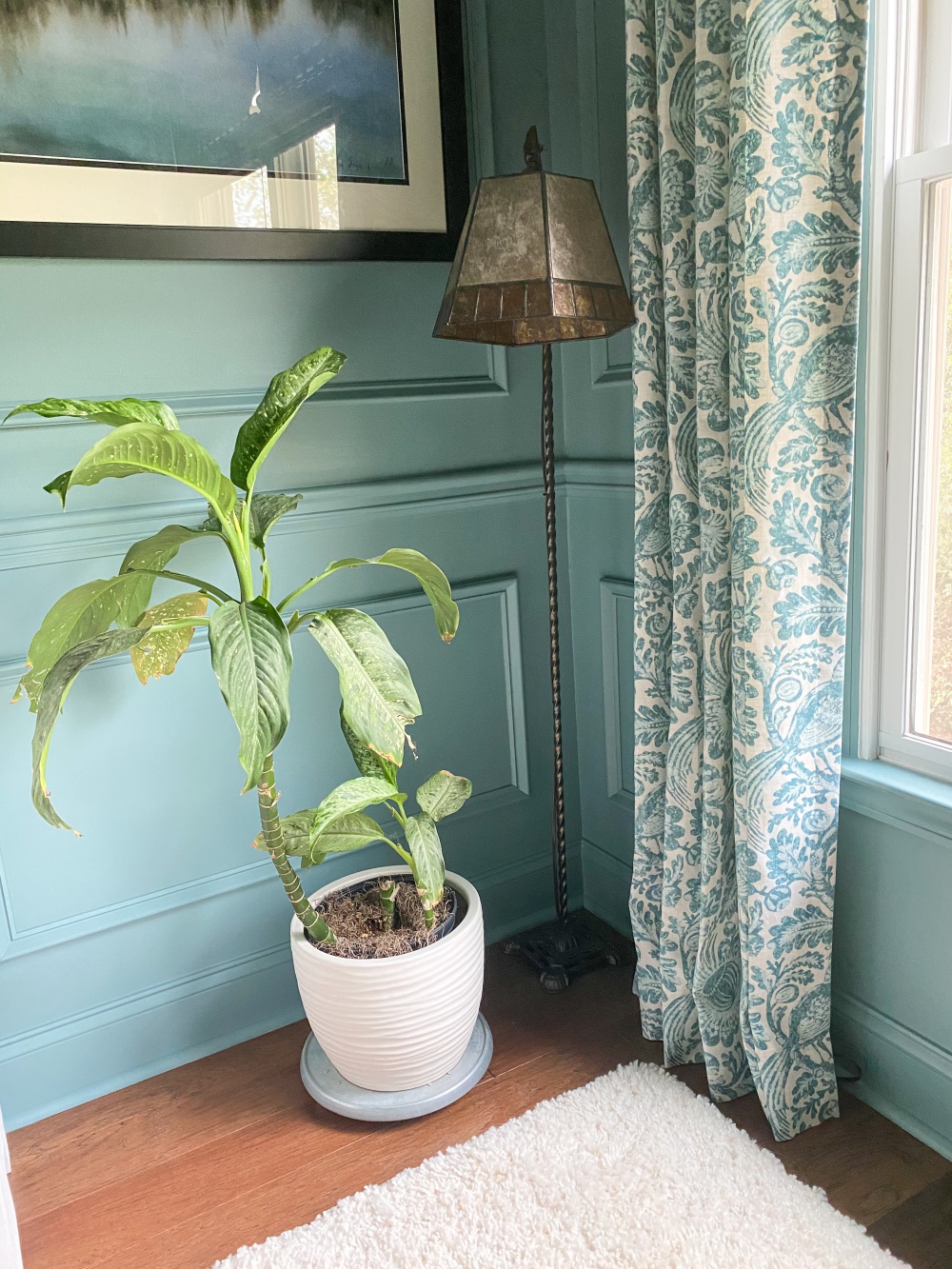 Moody blue sitting room with picture frame molding painted all one color