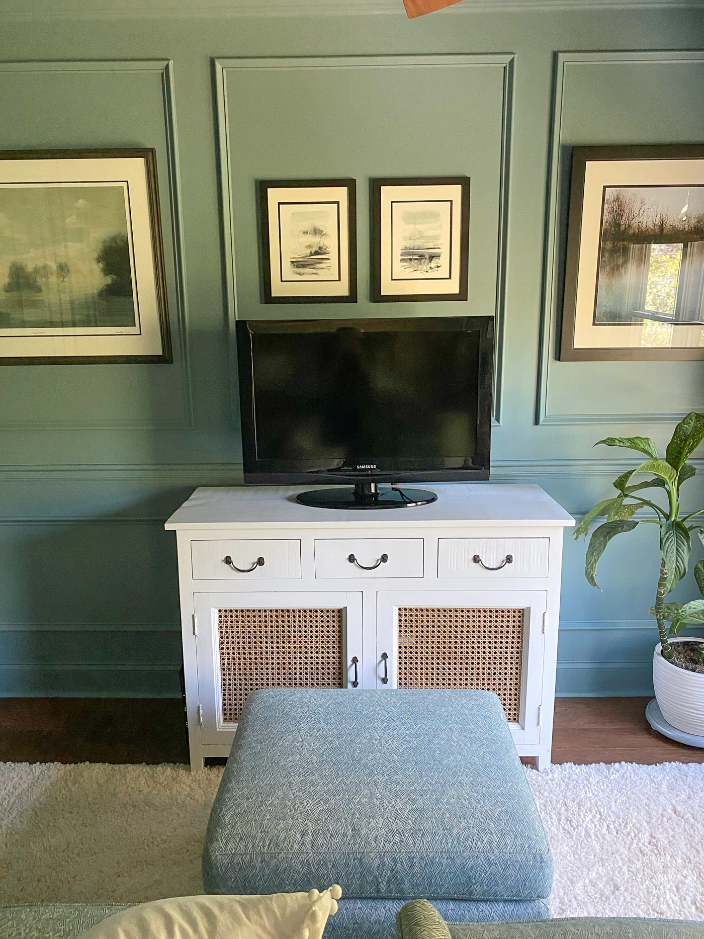 Moody blue sitting room with picture frame molding painted all one color