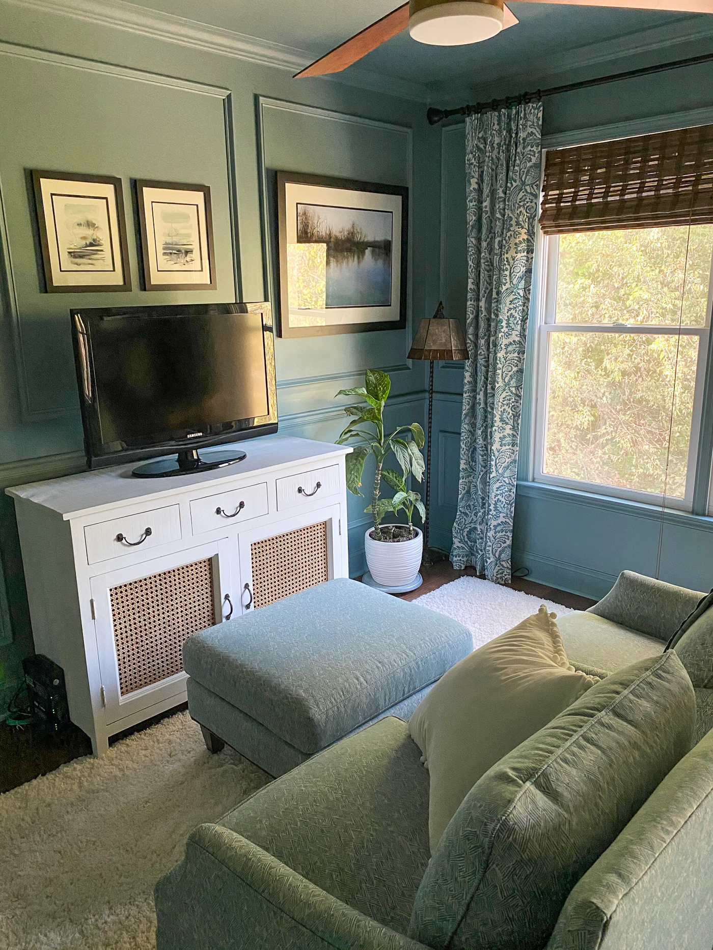 Moody blue sitting room with picture frame molding painted all one color