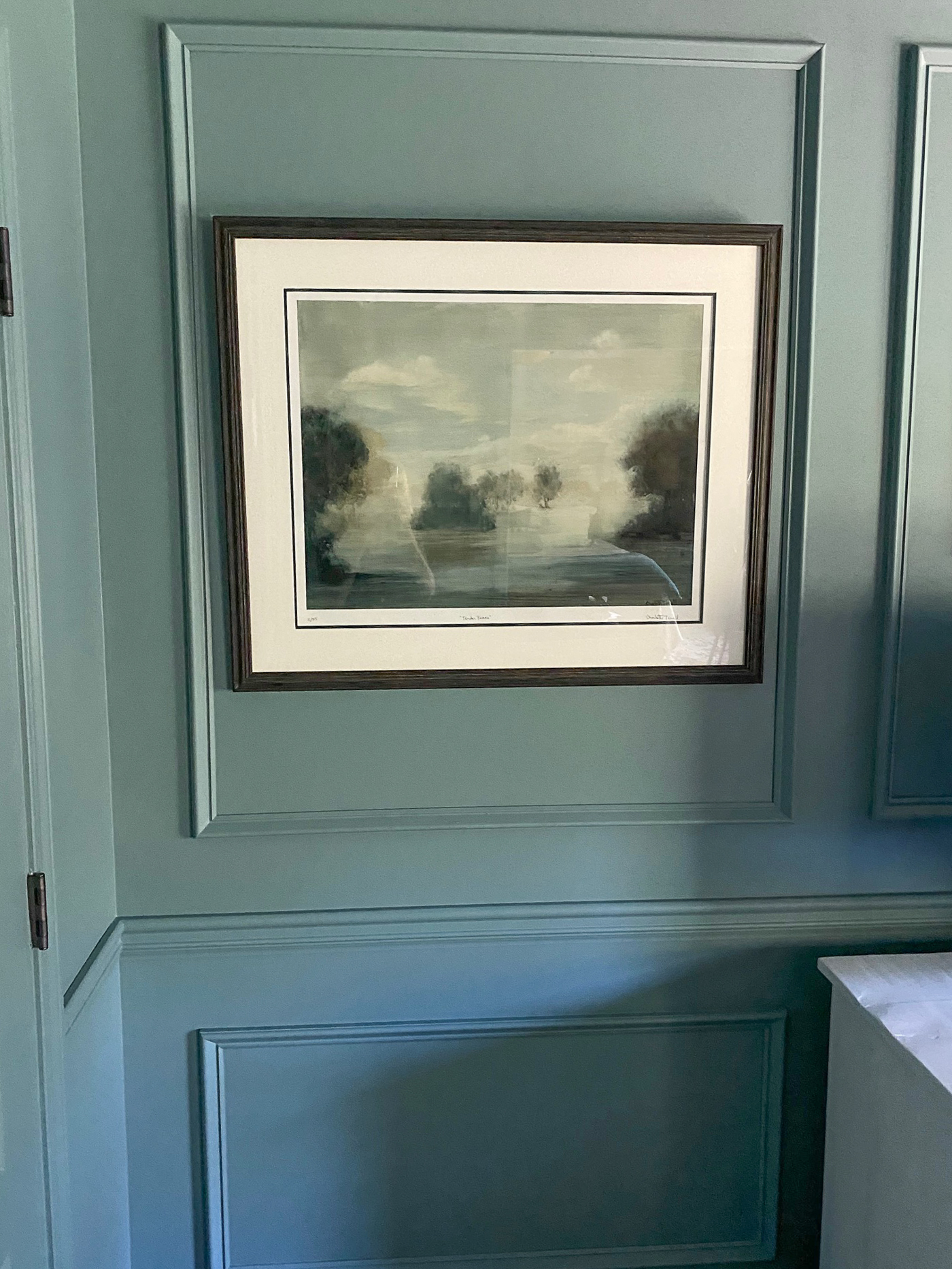 Moody blue sitting room with picture frame molding painted all one color