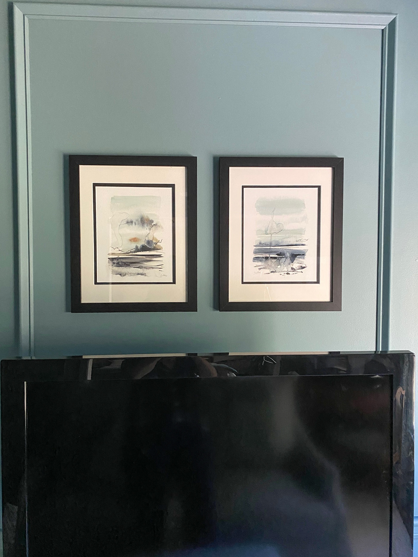 Moody blue sitting room with picture frame molding painted all one color